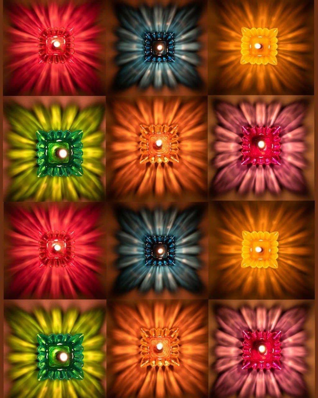 Grid of lit lotus reflection diyas in red, blue, orange, green and pink casting star-burst light patterns