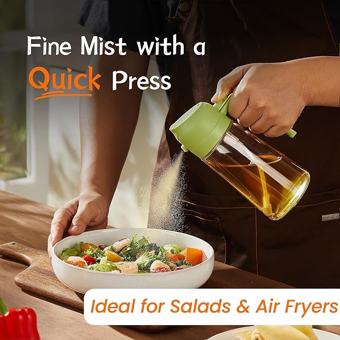 Hand pressing the oil sprayer to mist oil over a bowl of salad